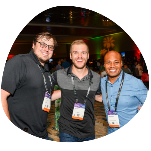 A photo of three men smiling for the camera