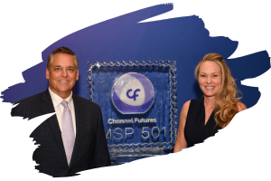 A photo of two people smiling and posing for a photo in front of an ice sculpture with the Channel Futures MSP 501 logo on it.