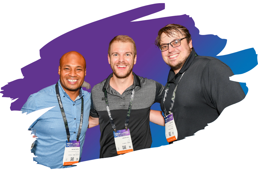 A photo of three men standing and smiling for the camera