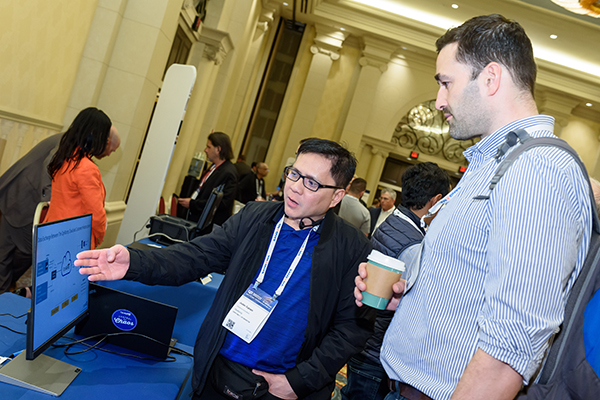 A vendor demonstrates their product to a partner during the MSP Summit Exhibition