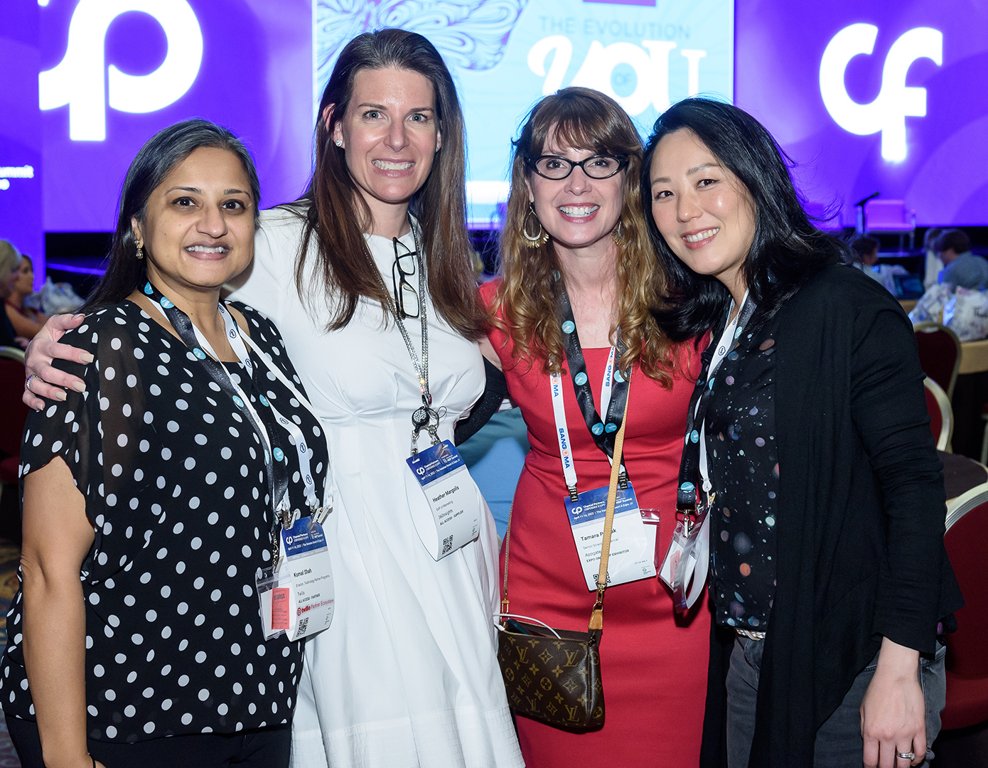 A photo of four women smiling for the camera