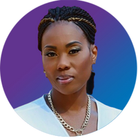 A photo of a Black woman with braids pulled back into a low bun. She is wearing a gold necklace.